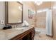 Well-lit bathroom with a large mirror, granite countertop, and tiled shower/tub combination at 2731 W Desert Ranch Rd, Phoenix, AZ 85086