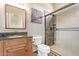Modern bathroom with a glass-enclosed shower, wooden vanity, and sleek fixtures at 2731 W Desert Ranch Rd, Phoenix, AZ 85086