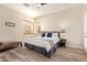 Bright bedroom with wood-look floors, a comfortable bed, and ample natural light from the windows at 2731 W Desert Ranch Rd, Phoenix, AZ 85086