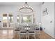 Bright dining room featuring a large bay window, a modern chandelier, and seating for six at 2731 W Desert Ranch Rd, Phoenix, AZ 85086