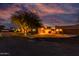 Desert home with attached garages, paved drive and warm lighting at dusk at 2731 W Desert Ranch Rd, Phoenix, AZ 85086