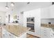 Gourmet kitchen with stainless steel appliances, custom white cabinetry, and granite countertops at 2731 W Desert Ranch Rd, Phoenix, AZ 85086