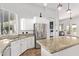 Bright kitchen with white cabinets, stainless steel appliances, and granite countertops at 2731 W Desert Ranch Rd, Phoenix, AZ 85086