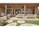 Inviting outdoor patio with a dining table, hanging chair, and manicured stone landscape design at 2731 W Desert Ranch Rd, Phoenix, AZ 85086