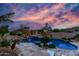 Backyard oasis with lush tropical landscaping, freeform pool, and lounge chairs at 2731 W Desert Ranch Rd, Phoenix, AZ 85086