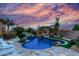 Inviting pool with mature landscaping, a waterfall feature, and chaise lounges at 2731 W Desert Ranch Rd, Phoenix, AZ 85086