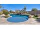 Inviting pool with a rock waterfall feature and lush landscaping creates a serene backyard oasis at 2731 W Desert Ranch Rd, Phoenix, AZ 85086