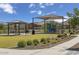 Community playground featuring modern play equipment and a covered picnic area at 2735 W La Mirada Dr, Laveen, AZ 85339
