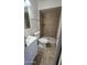 Modern bathroom featuring updated tile, a white vanity, and a walk-in shower at 2908 N 53Rd Ln, Phoenix, AZ 85031