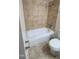 Bathroom featuring neutral tile and a tub and shower combination at 2908 N 53Rd Ln, Phoenix, AZ 85031