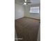 Comfortable bedroom featuring fresh carpeting, a ceiling fan, and a bright window at 2908 N 53Rd Ln, Phoenix, AZ 85031