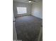 Spacious bedroom featuring fresh carpeting, a ceiling fan, and a bright window at 2908 N 53Rd Ln, Phoenix, AZ 85031