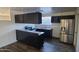 Modern kitchen showcasing dark cabinets, stainless steel appliances, and sleek countertops at 2908 N 53Rd Ln, Phoenix, AZ 85031