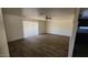 Spacious living room featuring wood floors, painted brick walls, and a sliding glass door at 2908 N 53Rd Ln, Phoenix, AZ 85031