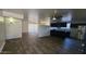 Open-concept living space with wood flooring seamlessly connecting the living room and kitchen at 2908 N 53Rd Ln, Phoenix, AZ 85031