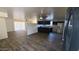 Inviting living space featuring wood floors, and an open layout of the living room and modern kitchen at 2908 N 53Rd Ln, Phoenix, AZ 85031