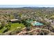 Aerial of a community with a large clubhouse, pool, park, and lush desert landscape at 31046 N 138Th Ave, Peoria, AZ 85383