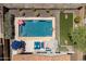 Aerial view of a beautiful pool with lounge chairs and a vibrant green lawn at 31046 N 138Th Ave, Peoria, AZ 85383