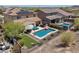 Aerial view showcasing a private pool, well-manicured backyard, and neighborhood at 31046 N 138Th Ave, Peoria, AZ 85383