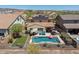 Aerial view of a beautiful pool with lounge chairs, bbq and vibrant green lawn at 31046 N 138Th Ave, Peoria, AZ 85383