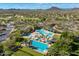 Aerial view of the community's pools, waterslides, and lounging areas amidst desert landscaping at 31046 N 138Th Ave, Peoria, AZ 85383