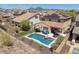 Aerial view of a home with a pool and beautiful outdoor entertainment area at 31046 N 138Th Ave, Peoria, AZ 85383