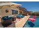 Inviting outdoor space with a refreshing pool, comfortable lounge area, and stylish patio furniture at 31046 N 138Th Ave, Peoria, AZ 85383