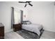 Cozy bedroom boasts a comfortable bed, side table, gray accents and a window with natural light at 31046 N 138Th Ave, Peoria, AZ 85383