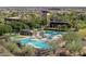 Relaxing community pool and clubhouse with lounge areas, umbrellas, and mountain views at 31046 N 138Th Ave, Peoria, AZ 85383