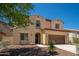 Charming two-story home featuring a brown two car garage, desert landscaping, and a welcoming entry at 31046 N 138Th Ave, Peoria, AZ 85383