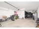 Spacious garage with high ceilings and ample room for vehicles, storage, and a workout area at 31046 N 138Th Ave, Peoria, AZ 85383