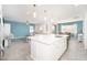 Bright kitchen with a large island and sink overlooking the living room and dining area with large windows at 31046 N 138Th Ave, Peoria, AZ 85383