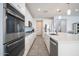 Kitchen with stainless steel appliances, tile floors, a large island with a sink and plenty of storage space at 31046 N 138Th Ave, Peoria, AZ 85383