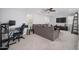 Comfortable loft area with a ceiling fan, lots of natural light, a desk, and a large sofa at 31046 N 138Th Ave, Peoria, AZ 85383