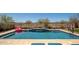 Sparkling swimming pool with mature trees, desert landscaping and waterfall feature creates a backyard oasis at 31046 N 138Th Ave, Peoria, AZ 85383