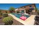 Inviting backyard pool with lounge chairs and an outdoor bar area, perfect for relaxing and entertaining at 31046 N 138Th Ave, Peoria, AZ 85383
