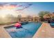 Refreshing pool with a playful flamingo float, ideal for relaxation and enjoying the outdoor living space at 31046 N 138Th Ave, Peoria, AZ 85383