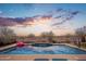 Relaxing pool with a serene water feature, perfect for evening swims with a stunning sunset backdrop at 31046 N 138Th Ave, Peoria, AZ 85383