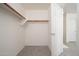 This walk-in closet features carpeted floors and built-in shelving and lots of natural light at 31046 N 138Th Ave, Peoria, AZ 85383
