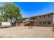 Backyard with low maintenance landscaping, fire pit, and chicken coop at 42160 W Arvada Ct, Maricopa, AZ 85138