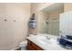 Bathroom features a wooden vanity and a walk-in shower at 42160 W Arvada Ct, Maricopa, AZ 85138