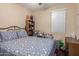 Bedroom featuring a full size bed and a window for natural light at 42160 W Arvada Ct, Maricopa, AZ 85138