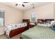 Shared bedroom with two beds, built-in storage, and a ceiling fan at 42160 W Arvada Ct, Maricopa, AZ 85138