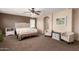 Spacious bedroom featuring neutral decor, a comfortable bed, and accent seating at 42160 W Arvada Ct, Maricopa, AZ 85138
