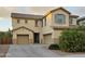 Inviting two-story home with a three-car garage, neutral stucco, and low-maintenance landscaping at 42160 W Arvada Ct, Maricopa, AZ 85138