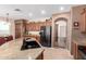 The kitchen features granite countertops, wood cabinets, and stainless steel appliances at 42160 W Arvada Ct, Maricopa, AZ 85138