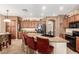 A kitchen features bar stool seating around a granite countertop island at 42160 W Arvada Ct, Maricopa, AZ 85138