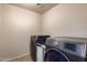 Laundry room featuring modern Samsung washer and dryer appliances at 42160 W Arvada Ct, Maricopa, AZ 85138