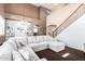 Spacious living room features a large sectional sofa and staircase at 42160 W Arvada Ct, Maricopa, AZ 85138