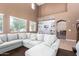 Cozy living room with large sectional, high ceilings and bright, natural light at 42160 W Arvada Ct, Maricopa, AZ 85138
